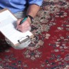 man inspecting rug